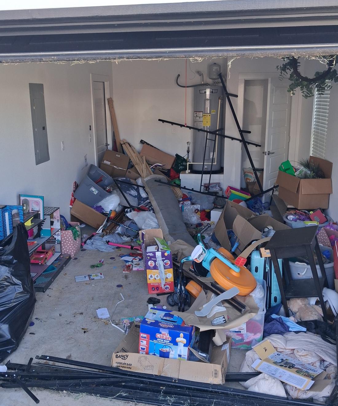 Before: a one-car garage in Northwest Arkansas packed with boxes, toys, bed frames, furniture and bags of junk